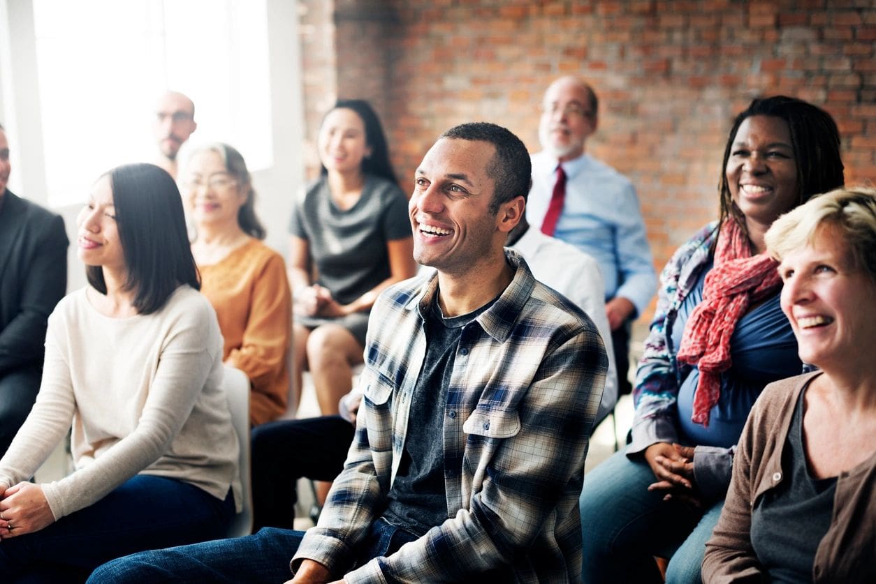 A group of people sitting in front of each other.